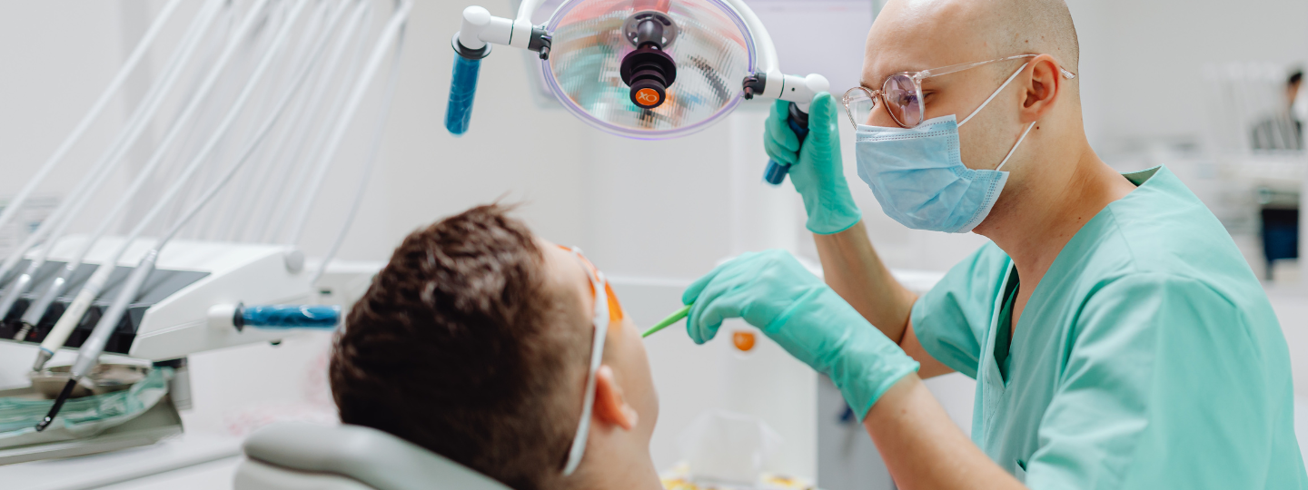 A dentist performing dental surgery on a patient.