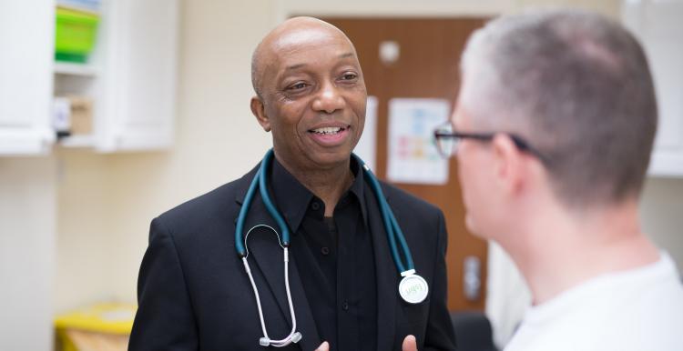 Male doctor speaking to a male patient