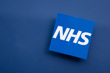 NHS logo on blue background.